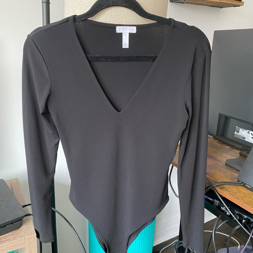 NWOT. Black body suit with snap closure